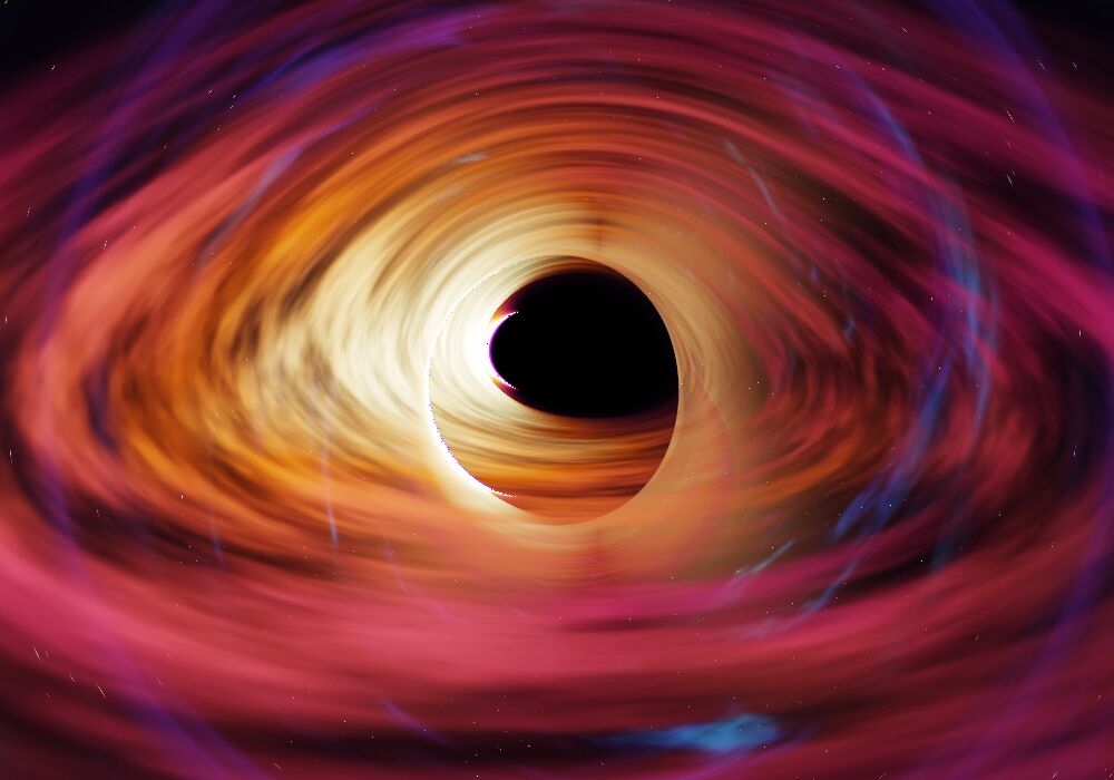 Close-up from the app: the black shadow, a thin bright ring at its edge, the glowing disk wrapped around it in orange and magenta.
